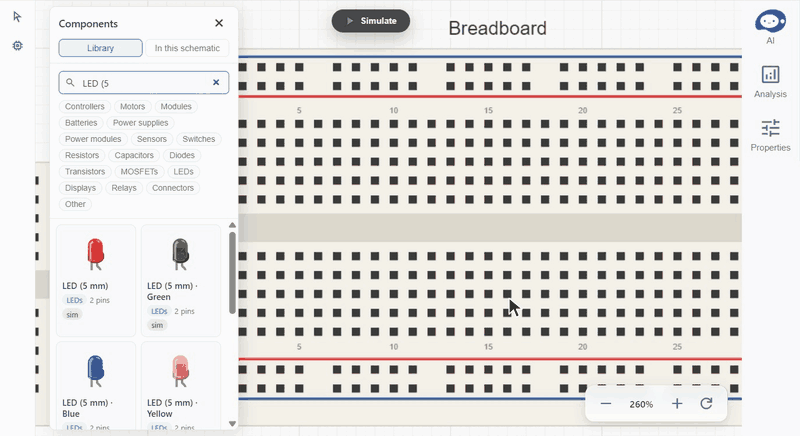 An LED dragged onto a breadboard. Its legs snap into two holes and join the strips they sit in